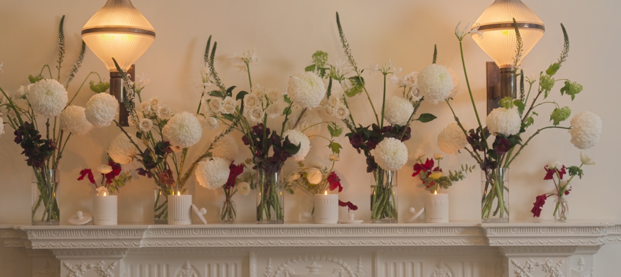 Jo Malone London Frieze Townhouse Candle Collection on mantelpiece with flowers